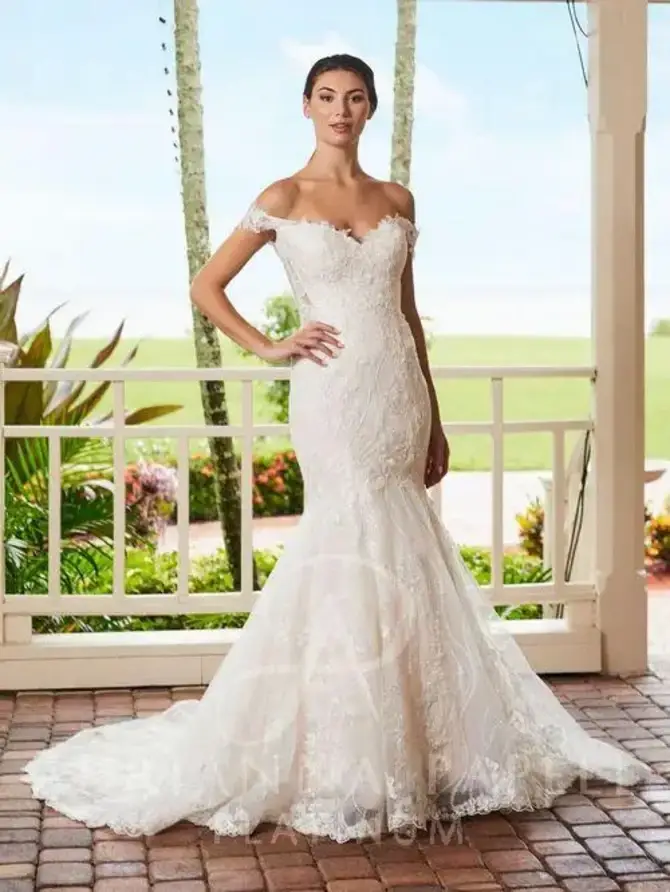 model is wearing an off the shoulder mermaid wedding dress