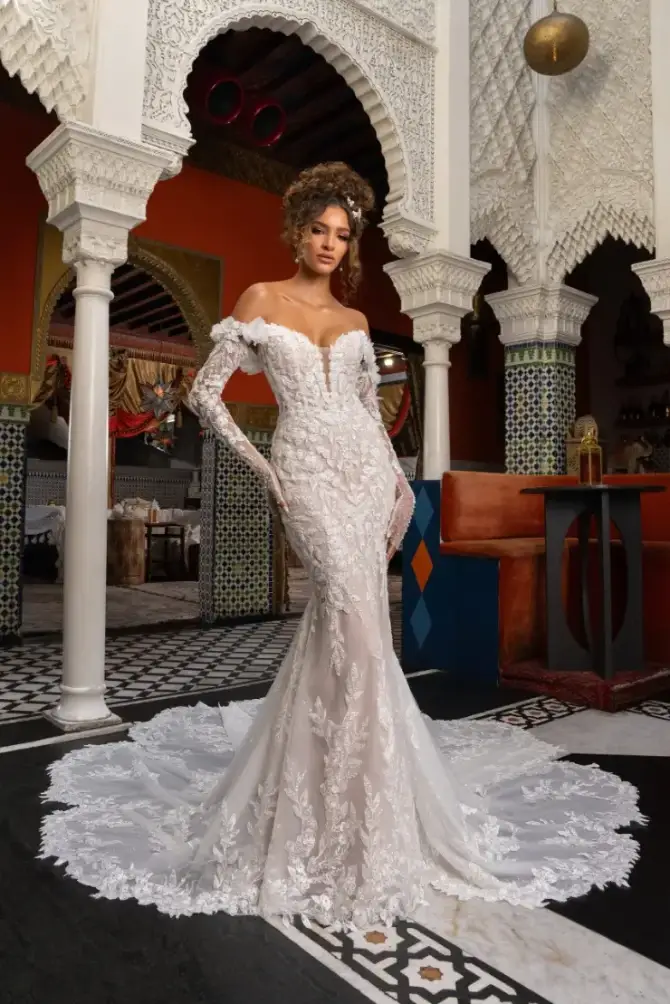 Model is wearing a fit and flare 3D floral appliques and off the shoulder long sleeves 