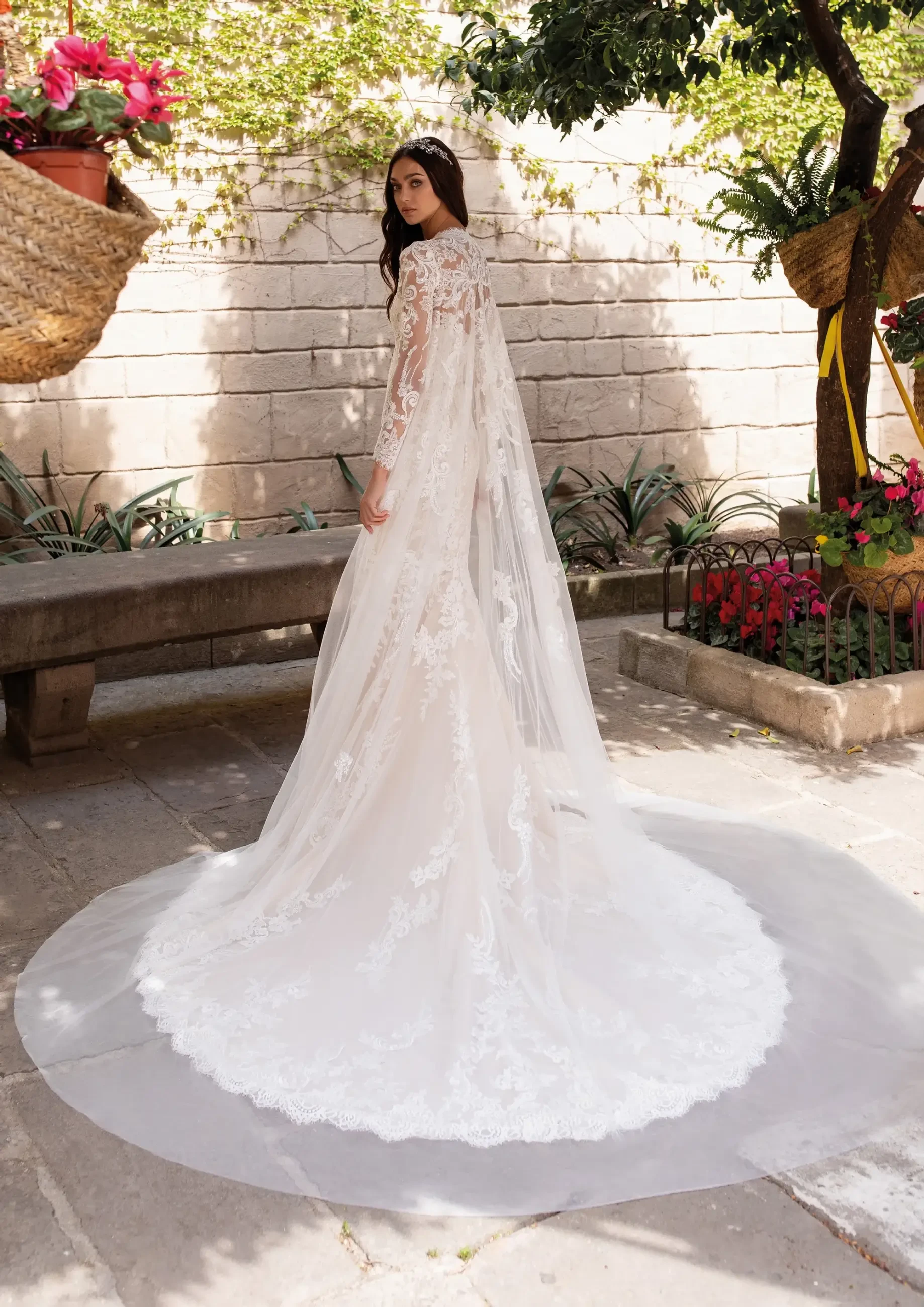 Model is wearing a lace mermaid wedding dress with a sweetheart neckline