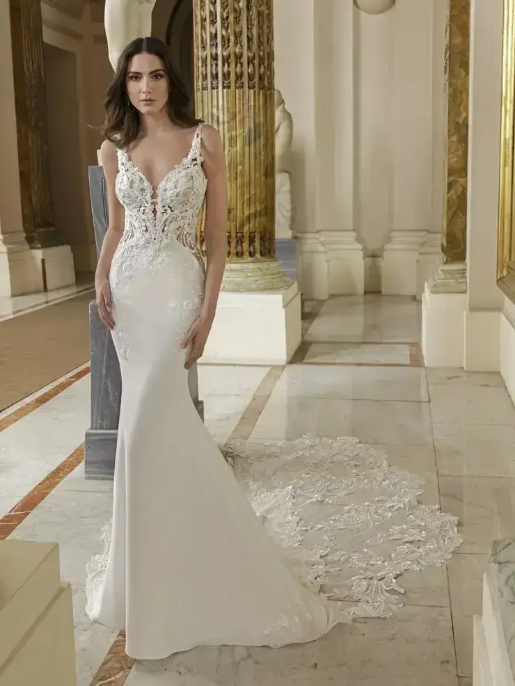 model is wearing a sleeveless fit and flare bridal gown