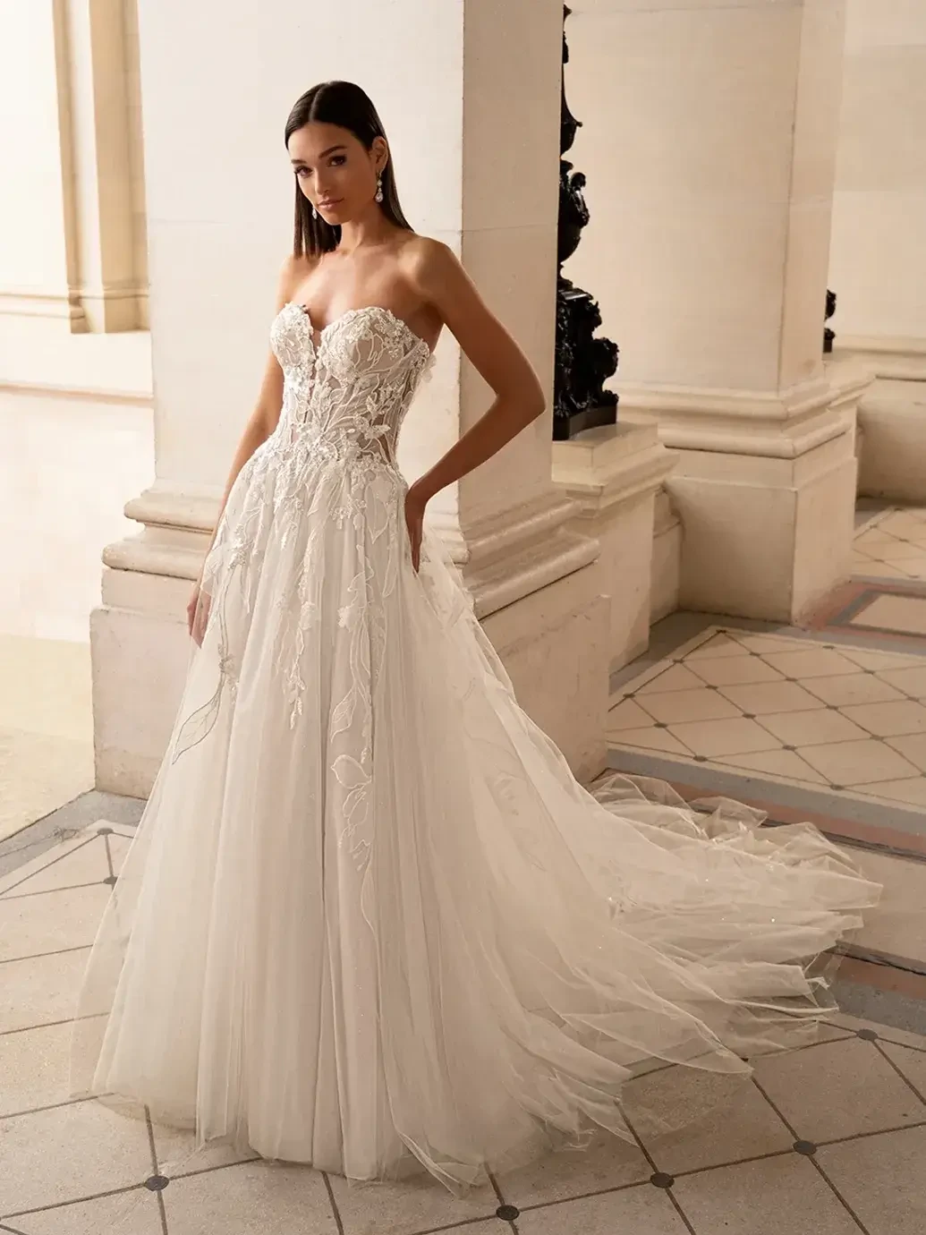 model is wearing a strapless a-line bridal gown