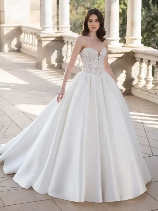 model is wearing a strapless ball gown wedding dress